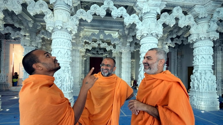 Hindu monks talk to each other at the first stone-built...