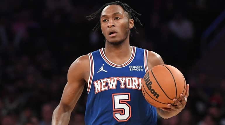 Knicks guard Immanuel Quickley dribbles the ball up court against...