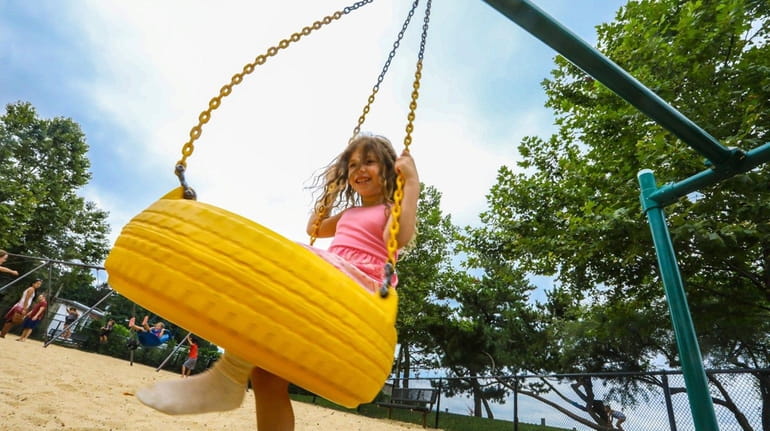Lyra Prestia, 6, of Centerport, plays at a Northport playground...