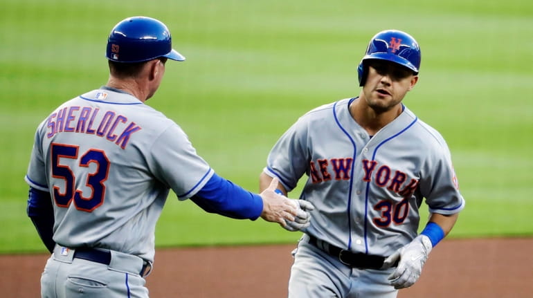 New York Mets' Michael Conforto, right, is congratulated by third...