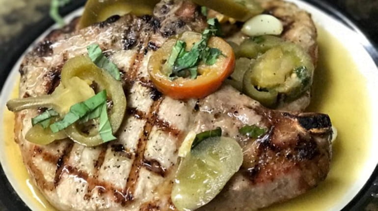 The Homestead 's center cut pork chops with cherry peppers.