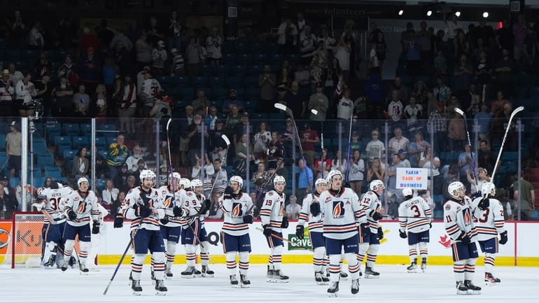 Kamloops Blazers players salute the crowd after defeating the Peterborough...
