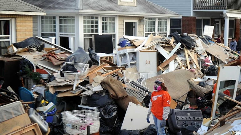 A member of the charity group Samaritan's Purse helps homeowners...