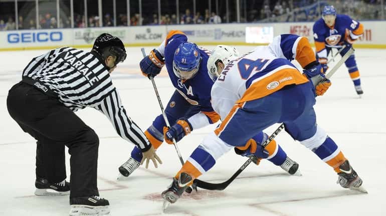 Islanders' John Tavares faces off with Scott Campbell in the...