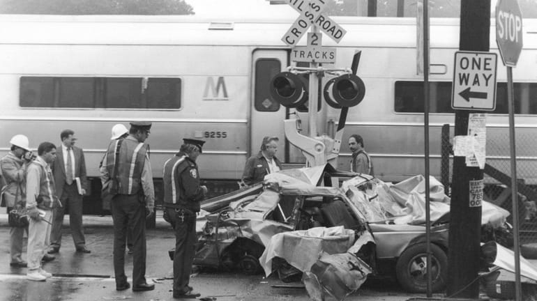 Authorities at the scene of an October 1993 crash where...