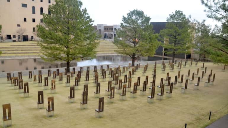168 symbolic empty chairs stand on the memorial site for...