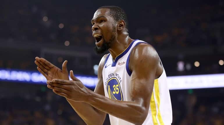 Kevin Durant #35 of the Golden State Warriors reacts during...