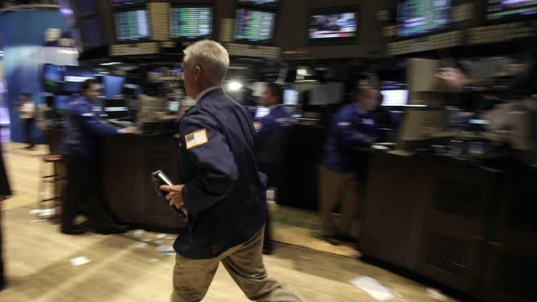 A trader strides across the floor of the New York...