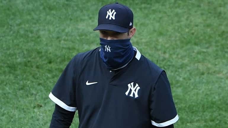 Yankees manager Aaron Boone walks to the dugout during the...