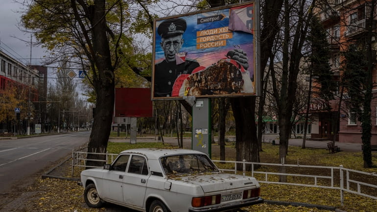 A partially torn-off Russian billboard in Kherson, southern Ukraine, Wednesday,...