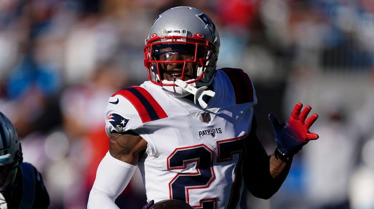 Patriots cornerback J.C. Jackson runs for a touchdown after an...