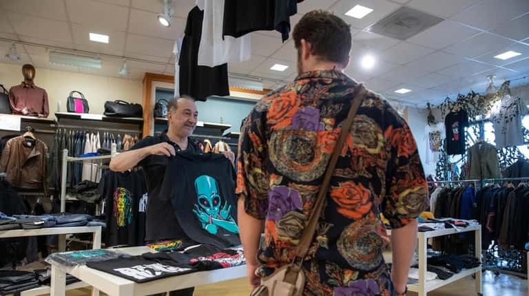 The Lud's owner, Lenny Ogeturk, suggests a shirt to shopper...