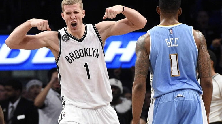 Brooklyn Nets center Mason Plumlee reacts after he sinks a...