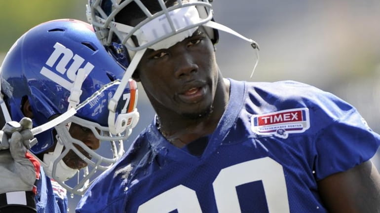 New York Giants' Jason Pierre-Paul cools off with some water...