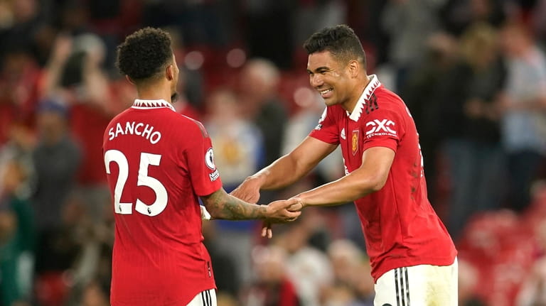 Manchester United's Casemiro, right, and Manchester United's Jadon Sancho celebrate...