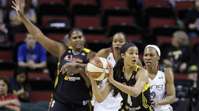 Tulsa Shock's Skylar Diggins looks to pass while defended by...