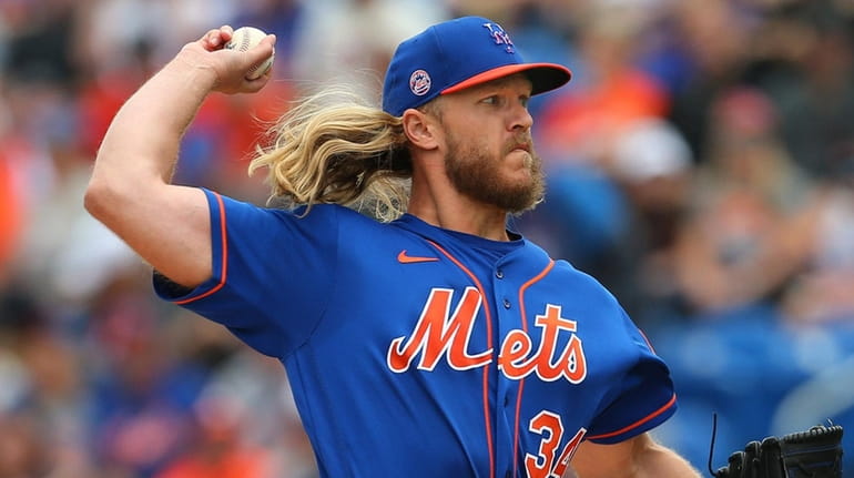 Mets pitcher Noah Syndergaard of the. Mets delivers a pitch against...