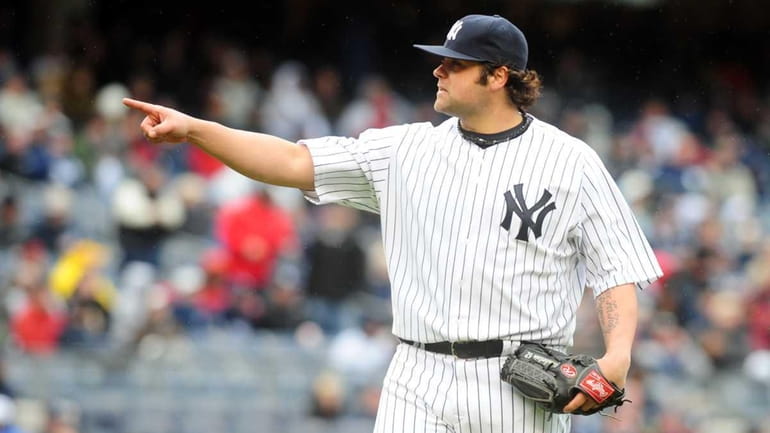 Yankees reliever Joba Chamberlain points while on the mound in...