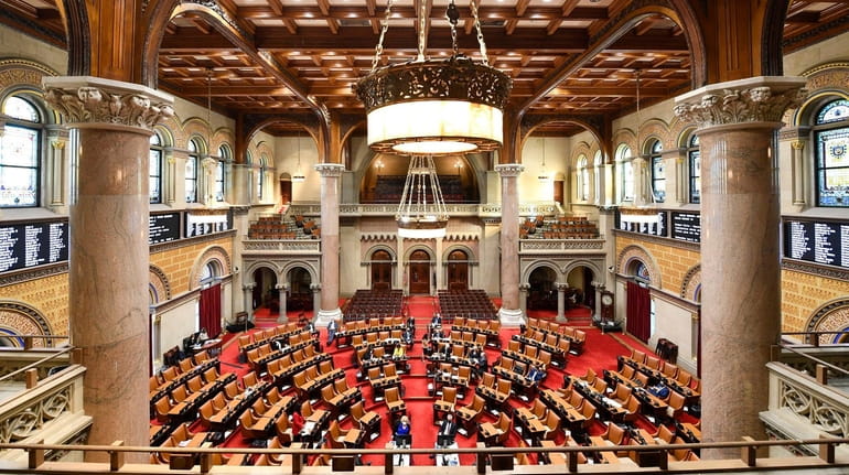 Members of the New York Assembly debate budget bills at...