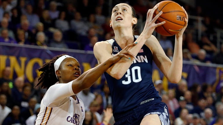 Connecticut's Breanna Stewart drives past East Carolina's I'Tiana Taylor during...