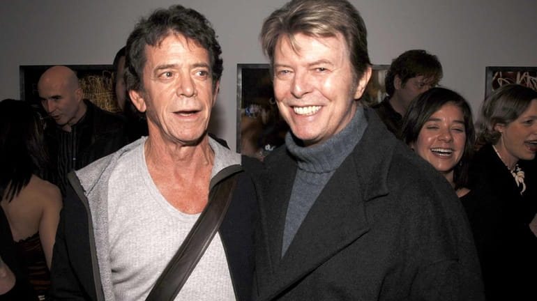 Lou Reed, left, and David Bowie attend the opening of...