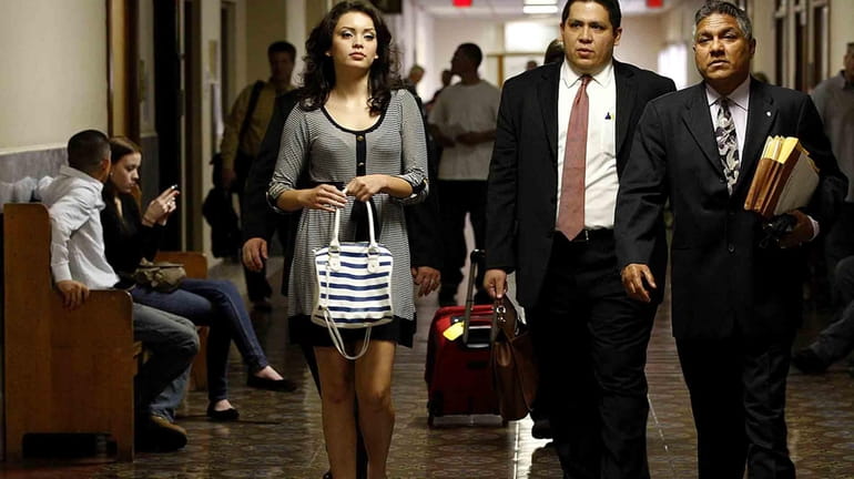 Domonique Ramirez, 17, left, walks through the courthouse in San...