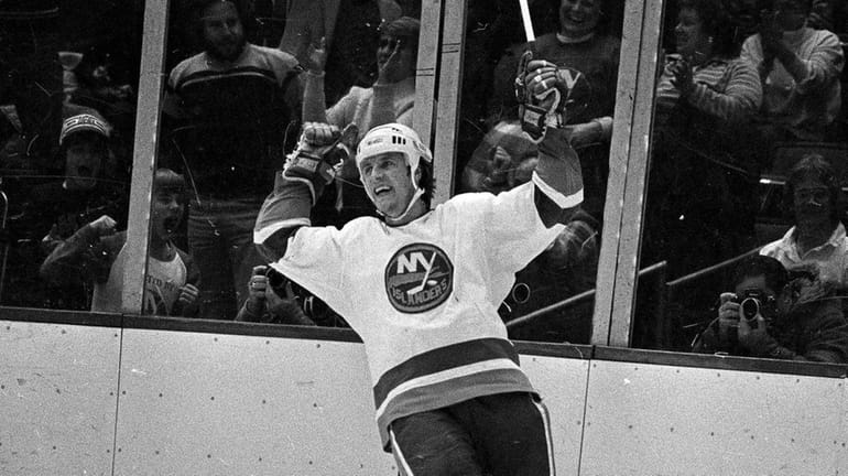 Islanders winger Mike Bossy cheers after his hat trick goal...