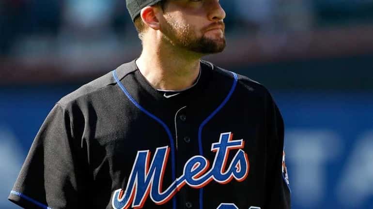 New York Mets' Bobby Parnell #39 walks back to the...
