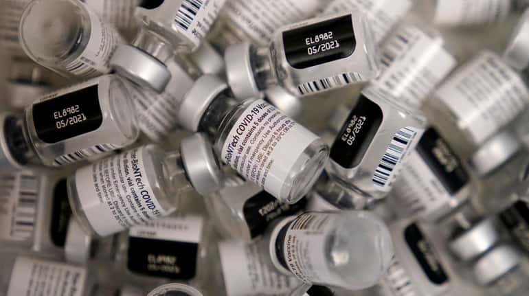 Empty vials of the Pfizer-BioNTech COVID-19 vaccine are seen at a...