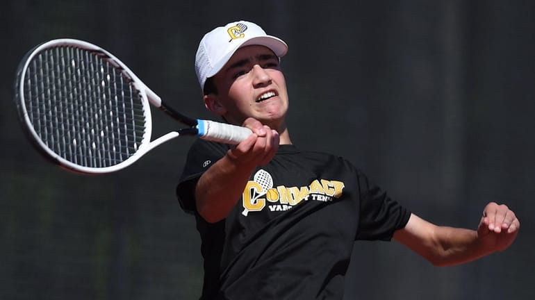 Eric Benderly of Commack returns a volley in fourth singles...