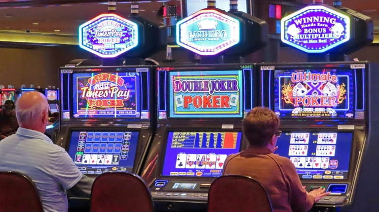 Gamblers play slot machines at Harrah's casino in Atlantic City...