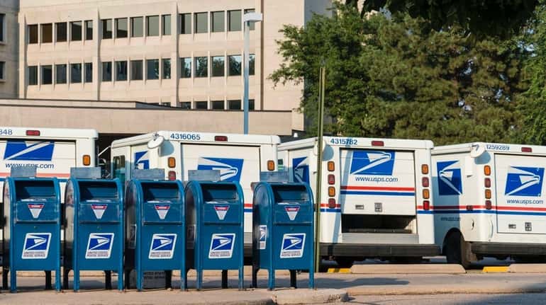 Delivery vehicles parked at the United States Post Office in...