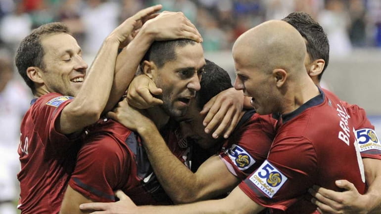 United States' Clint Dempsey, center, is congratulated by teammates after...