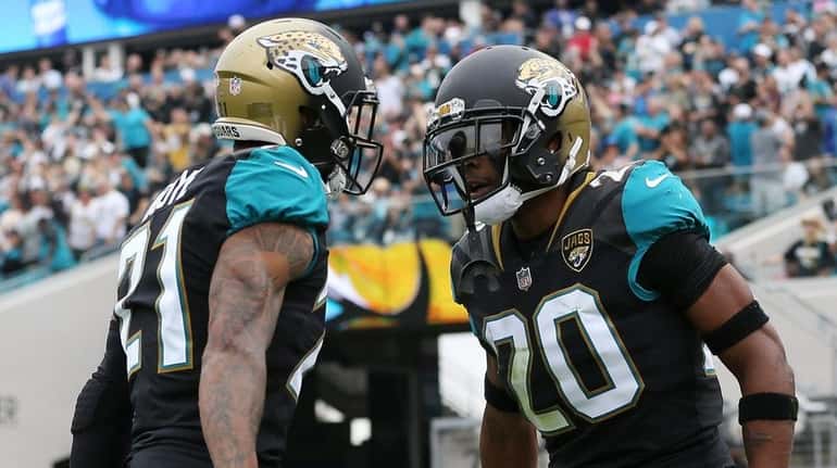 Jalen Ramsey and A.J. Bouye of the Jaguars celebrate after...