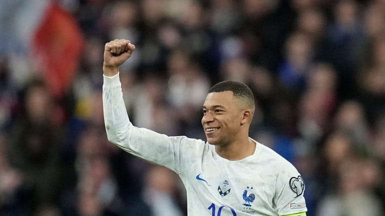 France's Kylian Mbappe celebrates after scoring his side's fourth goal...