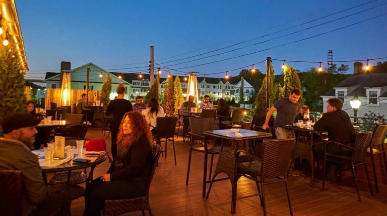 Patrons enjoy outdoor dining on Roslyn Social's heated rooftop patio.