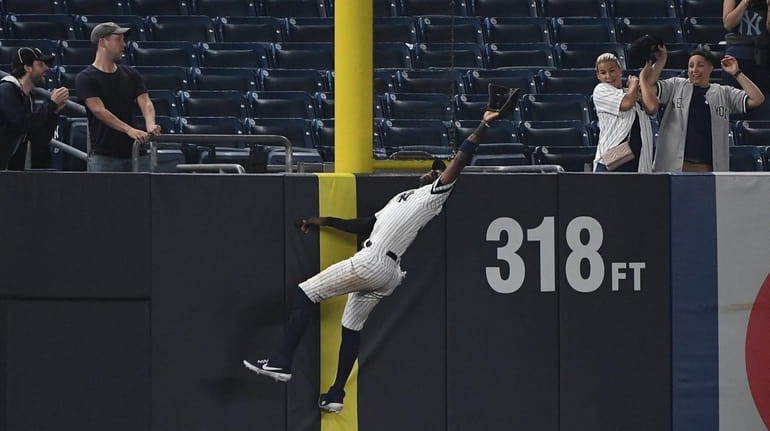 Yankees leftfielder Cameron Maybin is unable to make a catch...