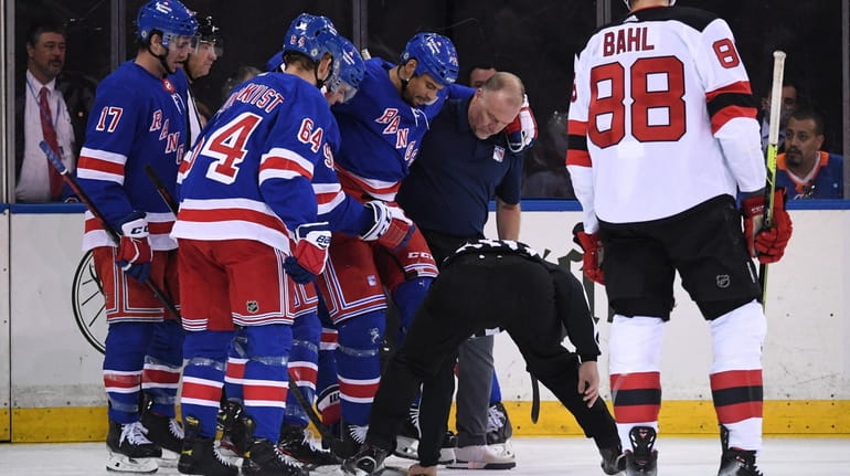 Rangers right wing Ryan Reaves is assisted off the ice...