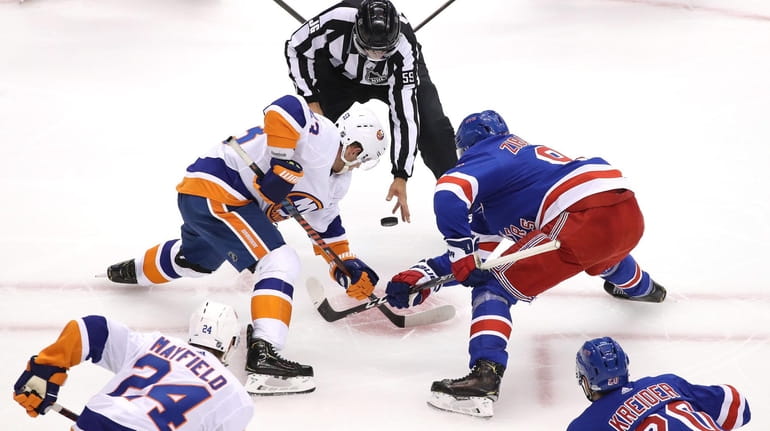 Casey Cizikas of the Islanders and Mika Zibanejad of the...