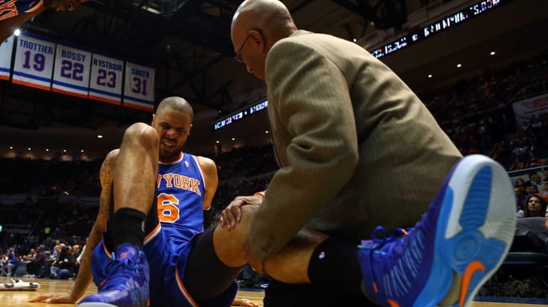 Tyson Chandler is tended to after suffering an injury early...