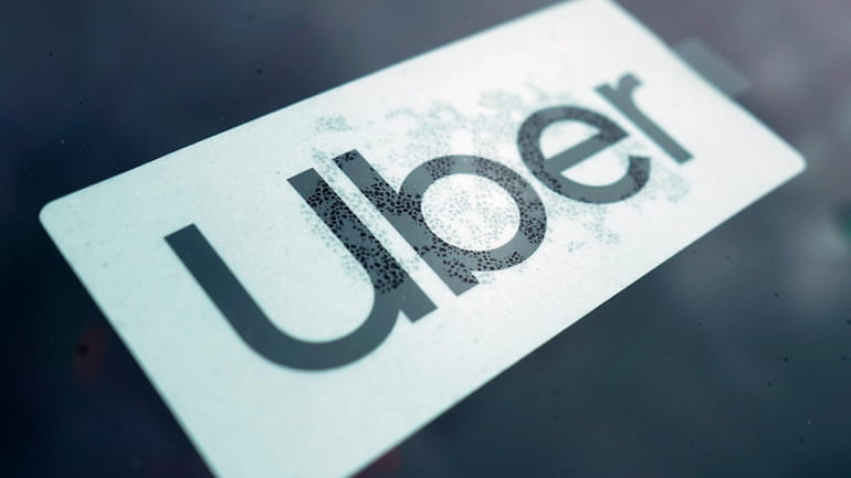 An Uber sign is displayed inside a car in Palatine,...