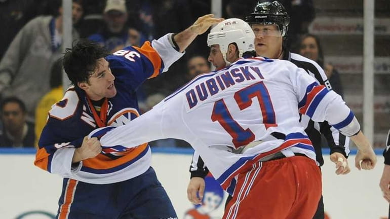 The Islanders' Jack Hillen fights the Rangers' Brandon Dubinsky during...