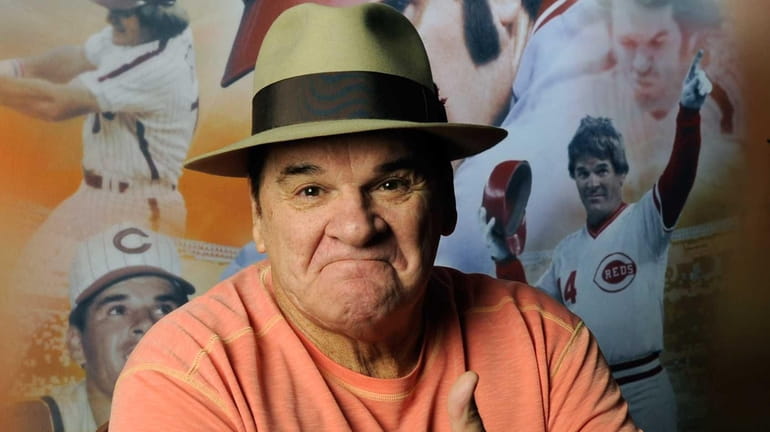 Pete Rose poses for a photograph before signing autographs at...