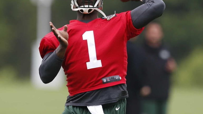 Jets quarterback Michael Vick throws a pass during an organized...