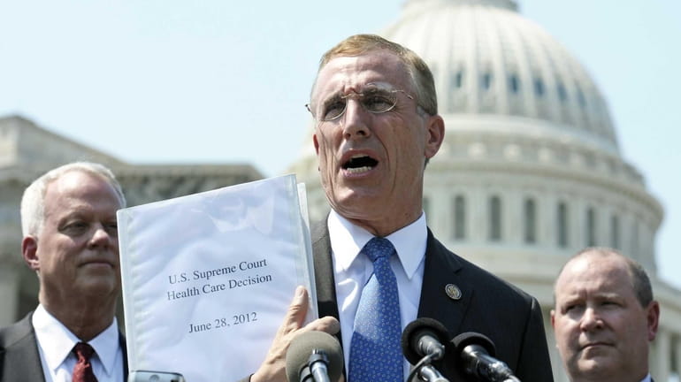 In this file photo, Rep. Tim Murphy, R-Pa., center, holds...