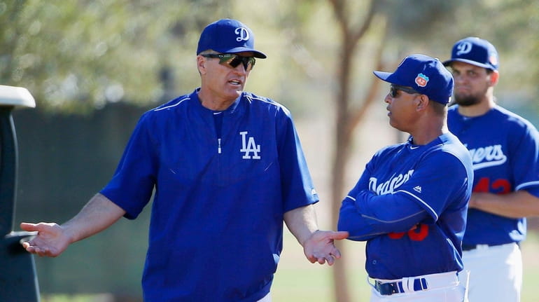 Bob Geren, left, talks to Dodgers manager Dave Roberts during...