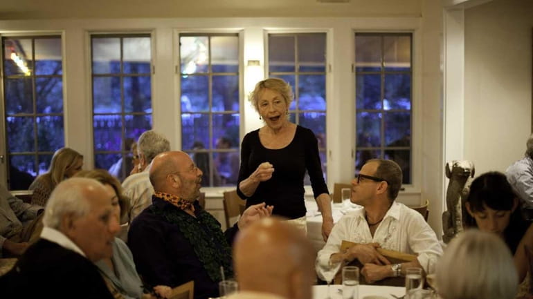 Bonnie Munshin speaks with customers during dinner Saturday night in...