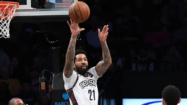 Nets forward Wilson Chandler passes the ball out from under...