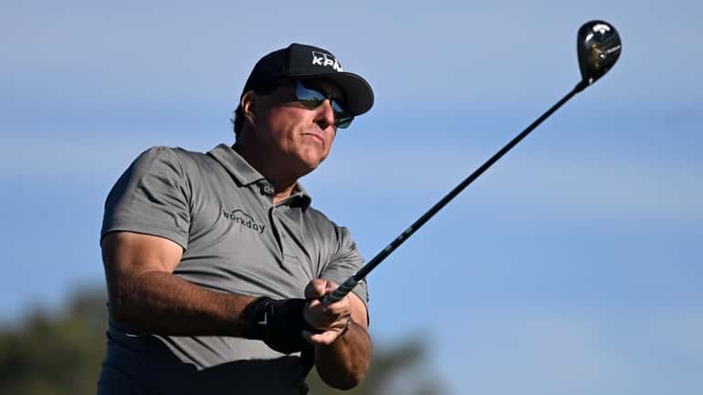 Phil Mickelson hits his tee shot on the fifth hole...