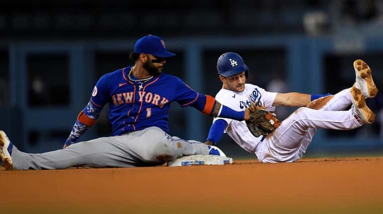 Jonathan Villar of the Mets tags out Trea Turner of...